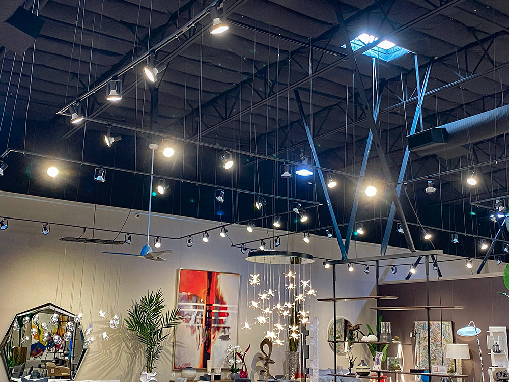 Furniture Warehouse using Total Track Lighting suspension system and track lighting to illuminate their showroom